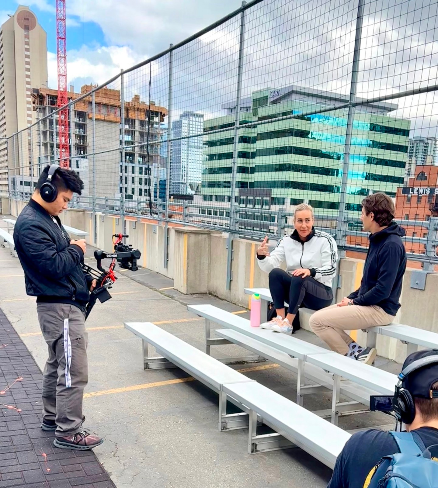 Ryan Yip operating a camera gimbal during an on-location interview shoot in downtown Calgary